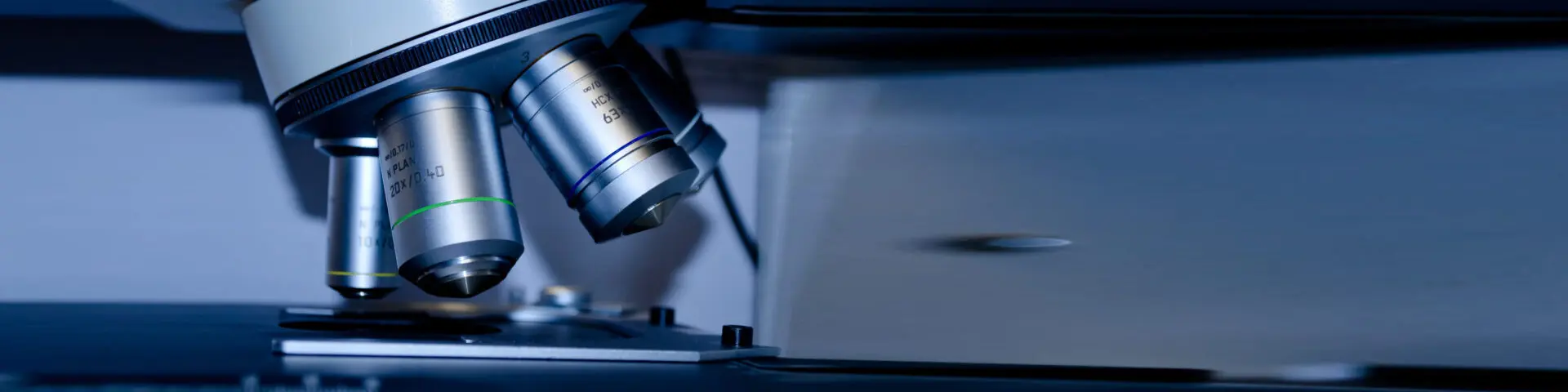 A close up of a microscope on top of a table